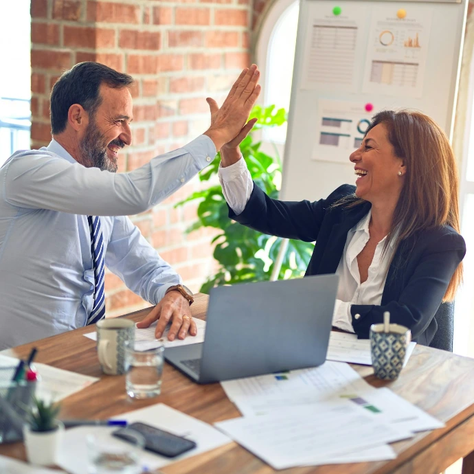 man in white dress shirt sitting beside woman in black long sleeve shirt